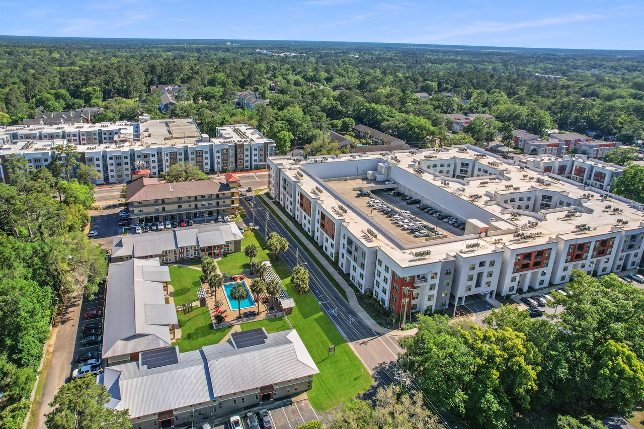 A broader aerial view of Chapel Hill, showcasing residential buildings, streets, and green spaces within the community.