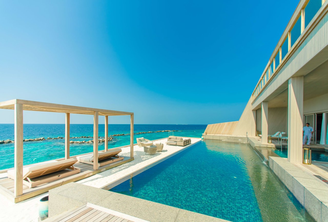 a pool area with a beach view