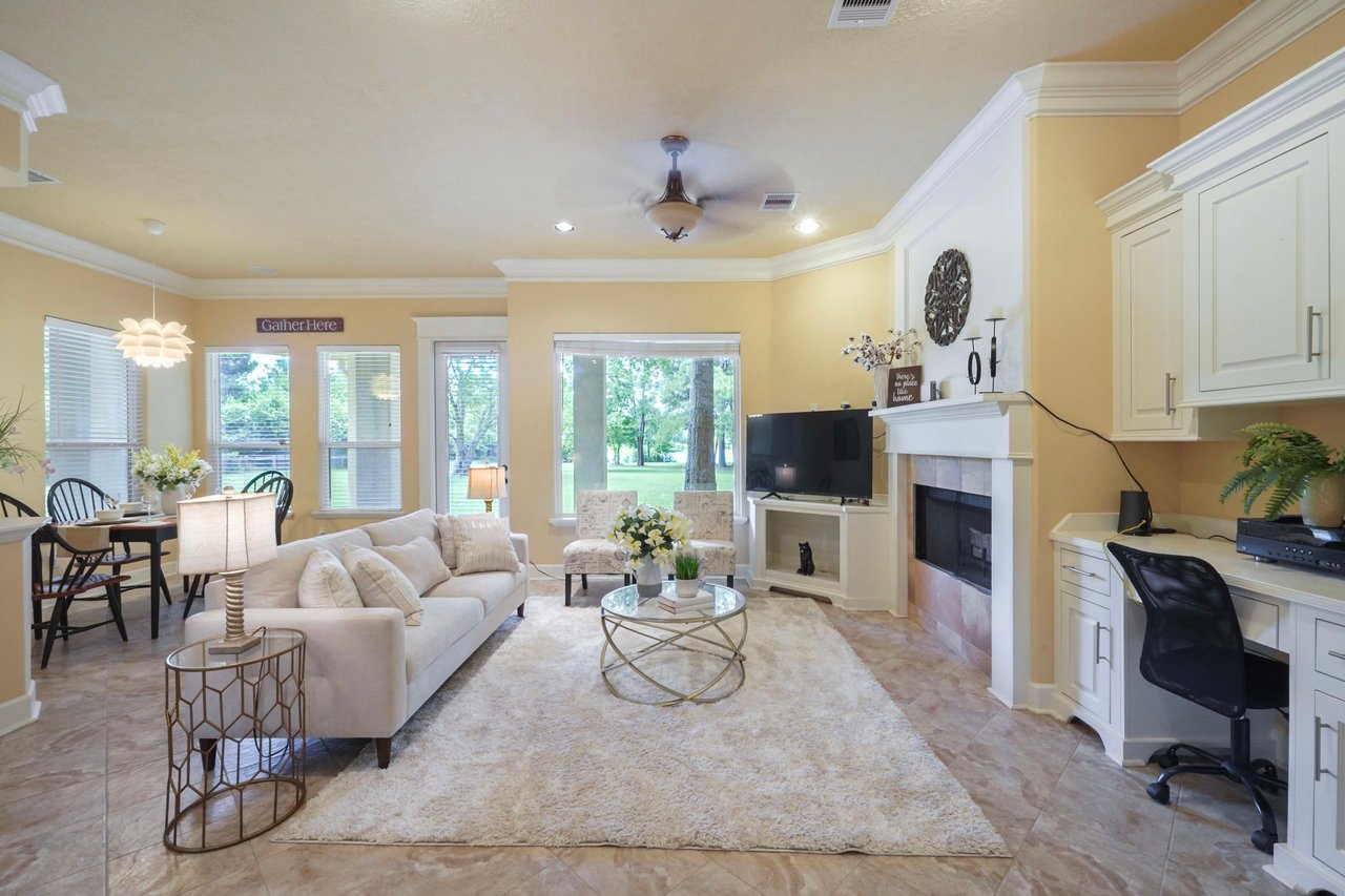 Den off the kitchen with second fire place, built in work desk, breakfast area, with door to the covered porch that runs the length of the home. Plenty of room to entertain!