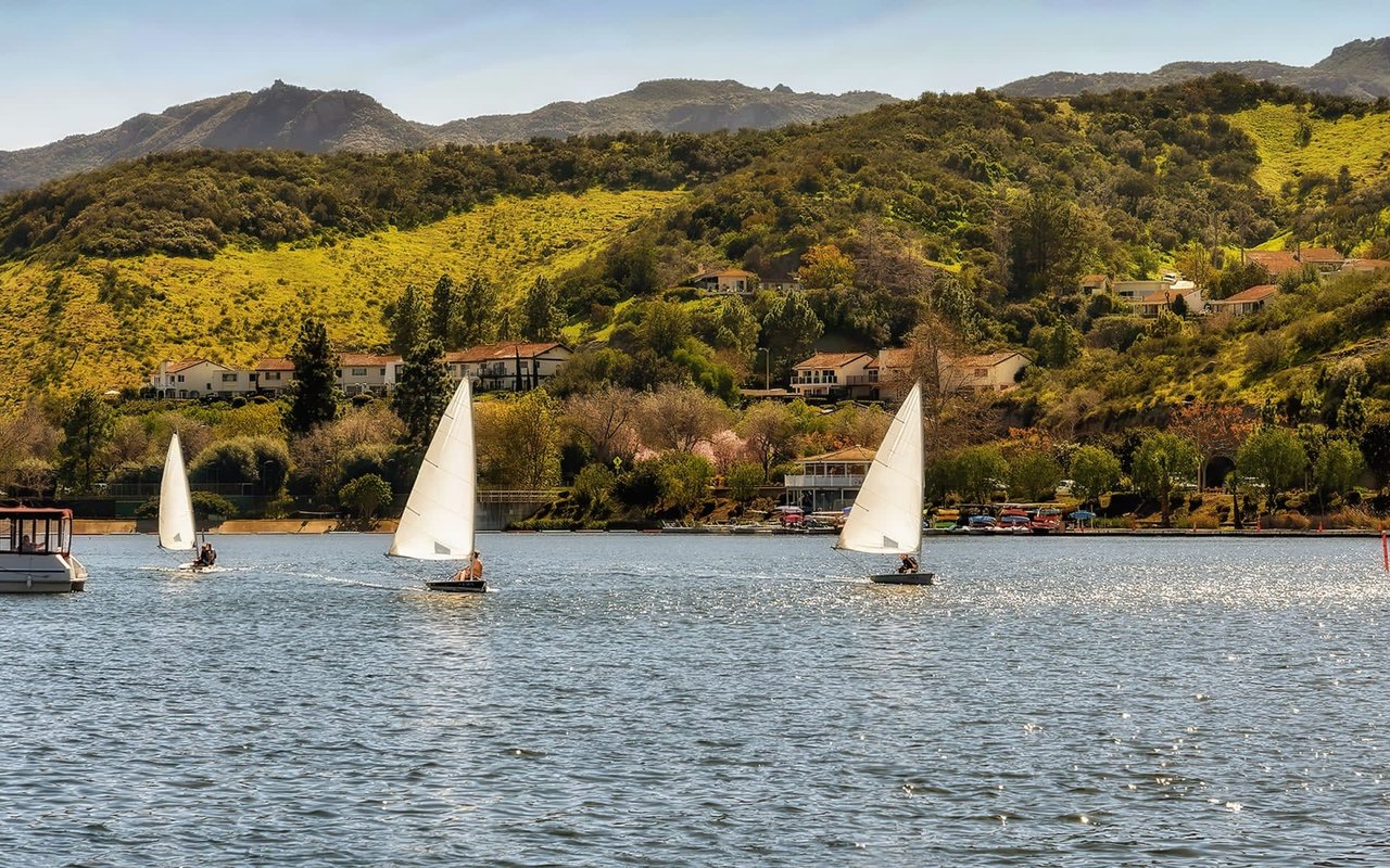 A picturesque scene of sailboats enjoying the calm waters of Westlake Lake in Westlake Village, California. 