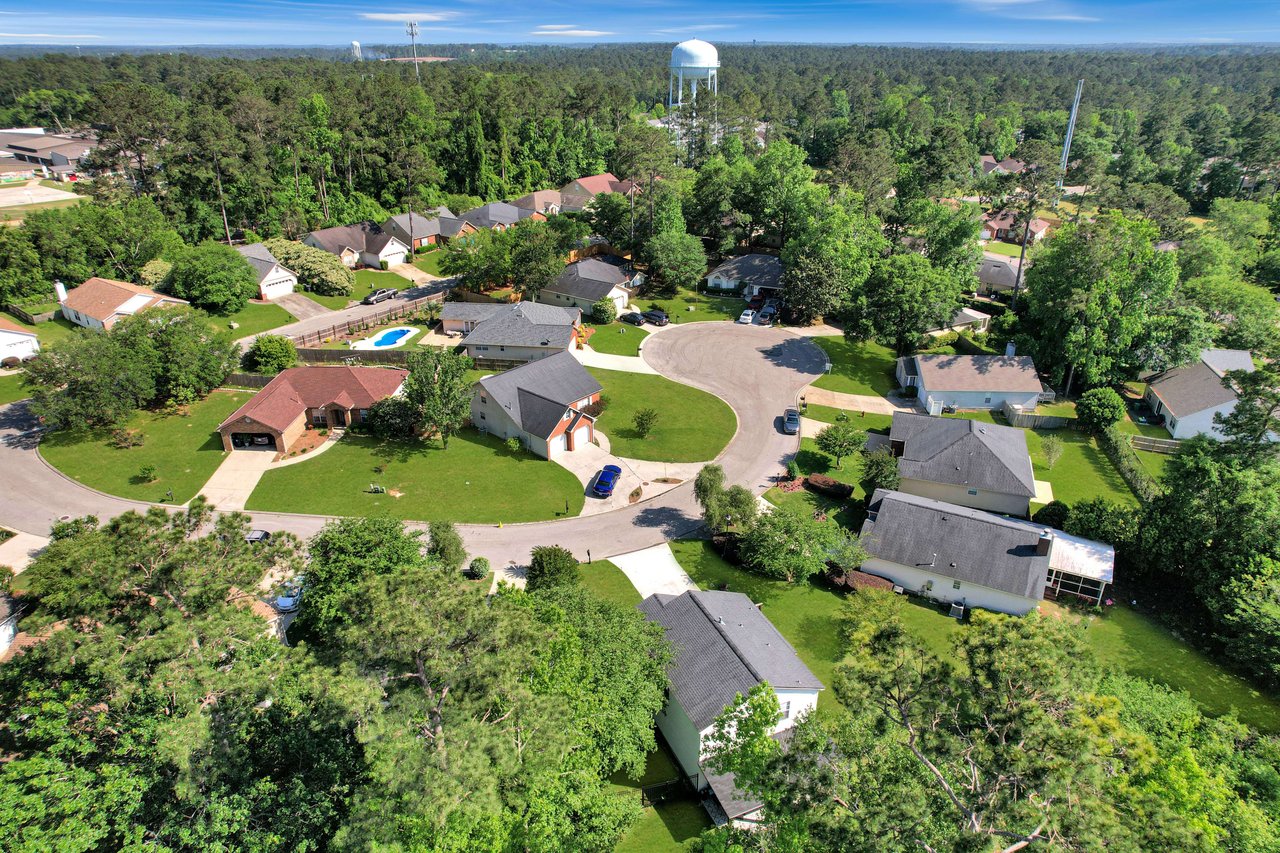 Another aerial view of Killearn Lakes, highlighting a neighborhood with houses and tree-lined streets.