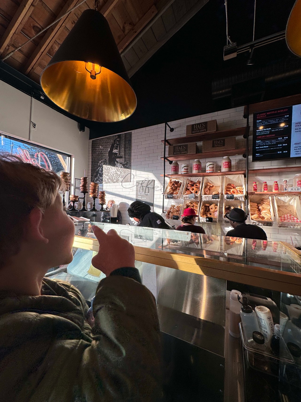 Heather Cumming's Son enamoured by the atmosphere of Bronx Bagel Buggy in Chamblee, GA