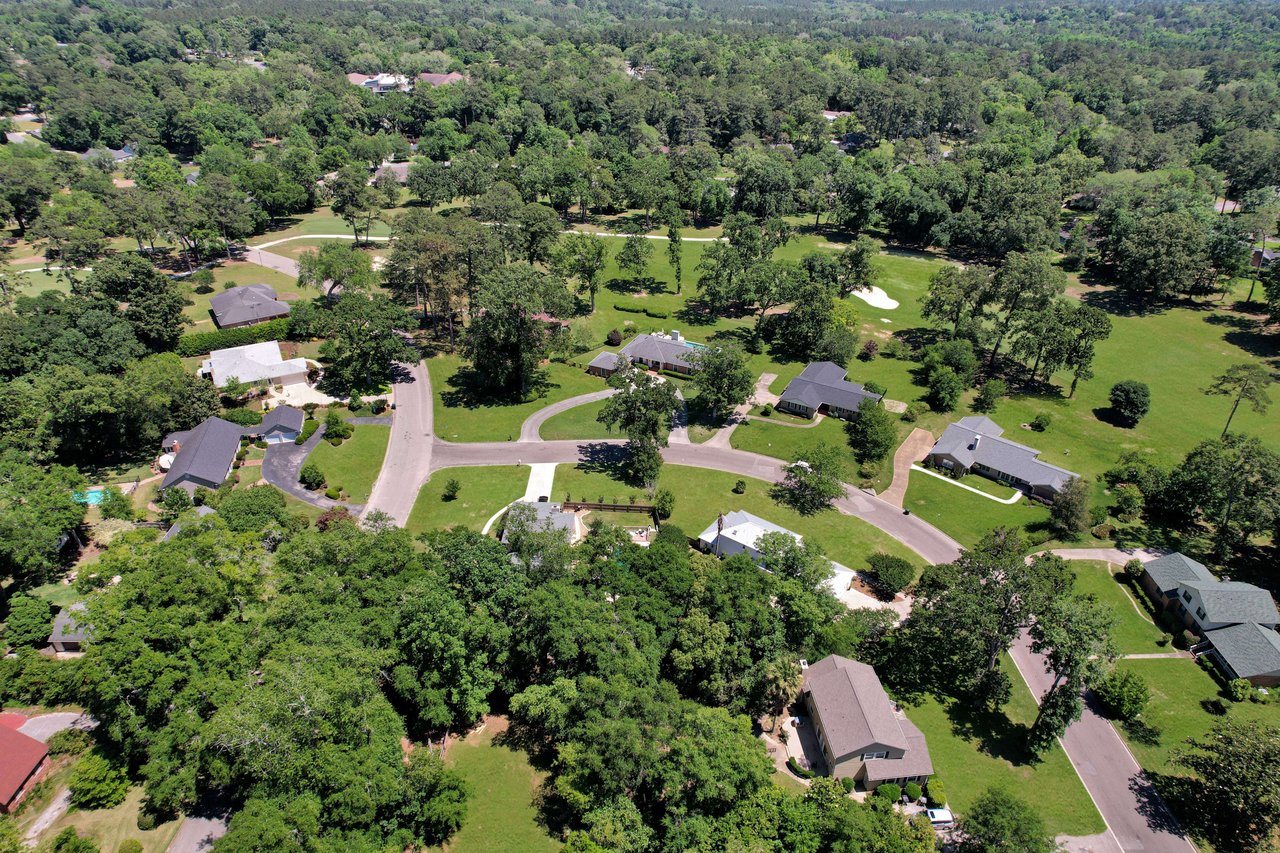 An aerial view of the Killearn Estates community, showing houses, streets, and greenery.