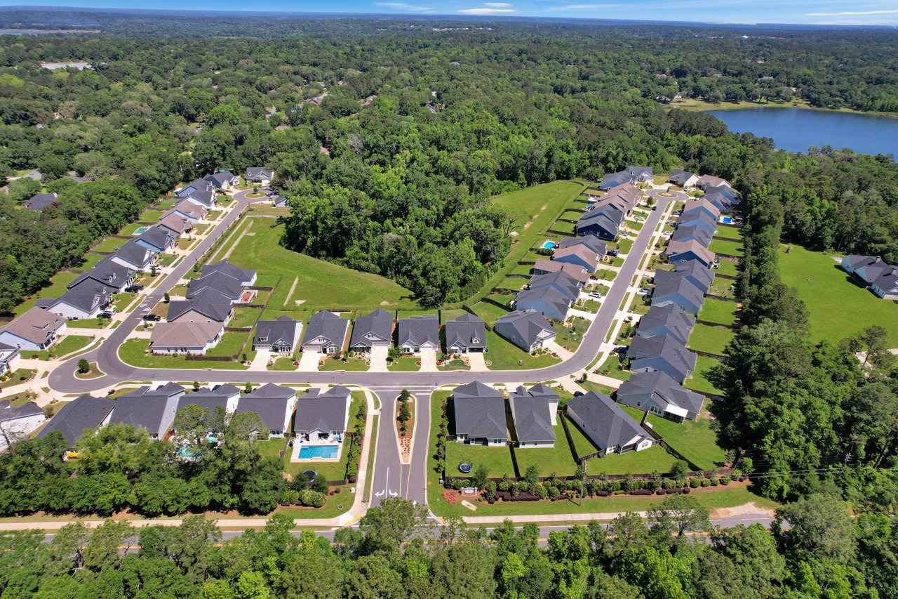 An aerial view of the Ox Bottom Manor community, showing houses, streets, and surrounding greenery.