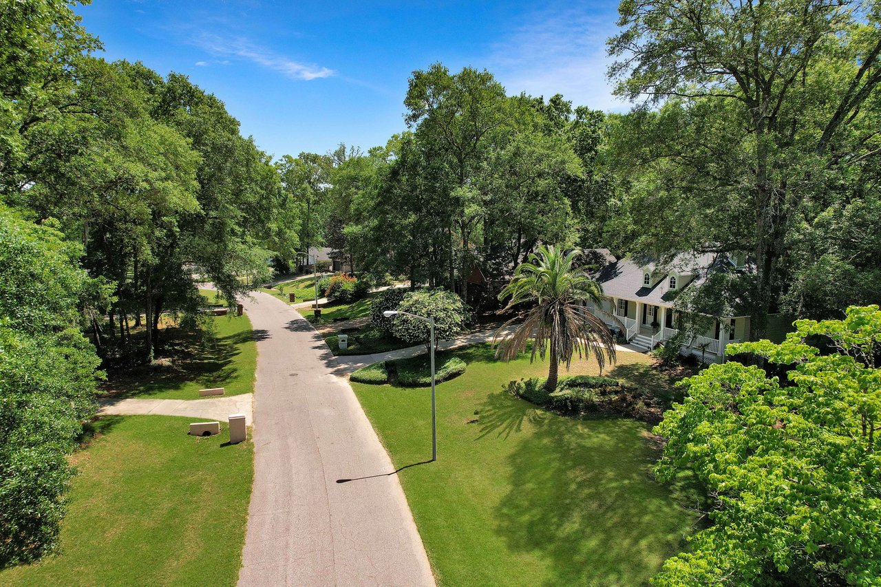 An aerial view of the street in the Benjamin's Run community showing well-maintained lawns, houses, and tree-lined streets.