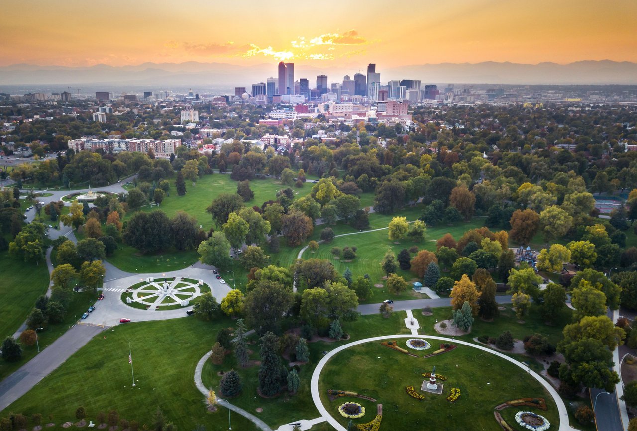  An aerial view of a sprawling city park with lush green grass and numerous trees