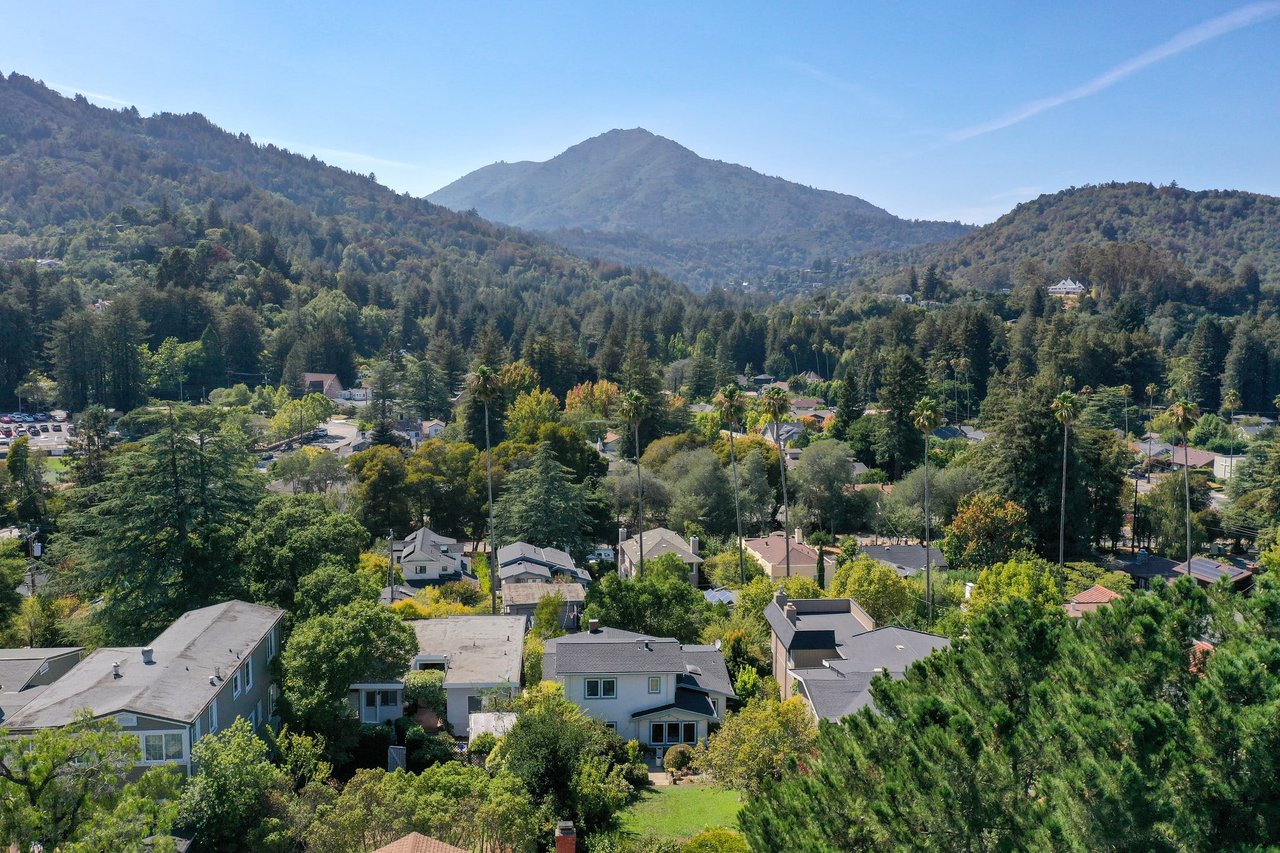 An aerial view of a suburban neighborhood with mountains in the background.