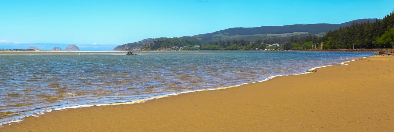 View of community of Netarts Oregon looking across the bay at Oceanside on a sunny day