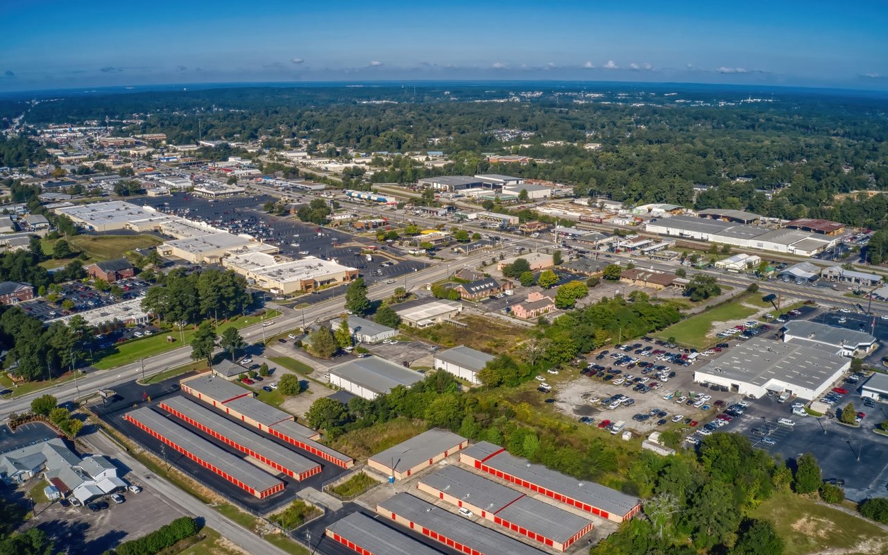 An aerial view of a suburban area with a large self-storage facility