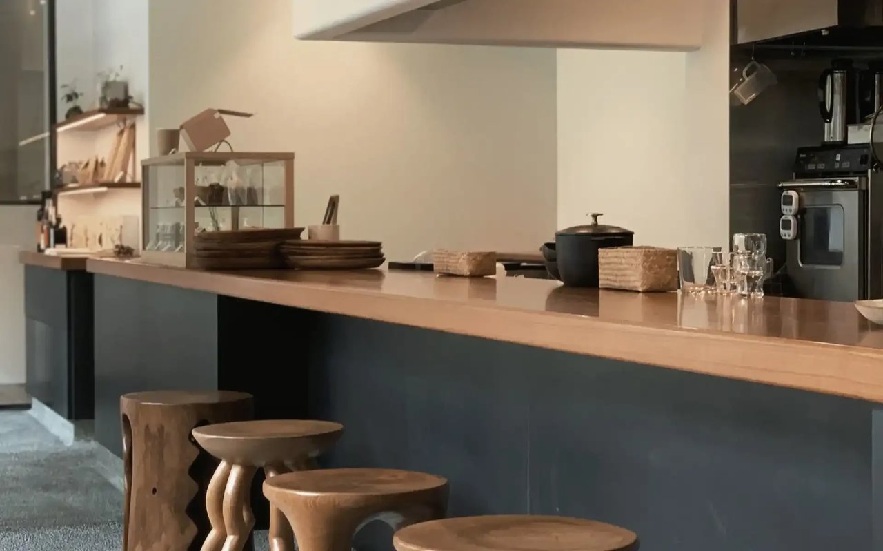  A spacious and inviting dining area with a long, light wood table.