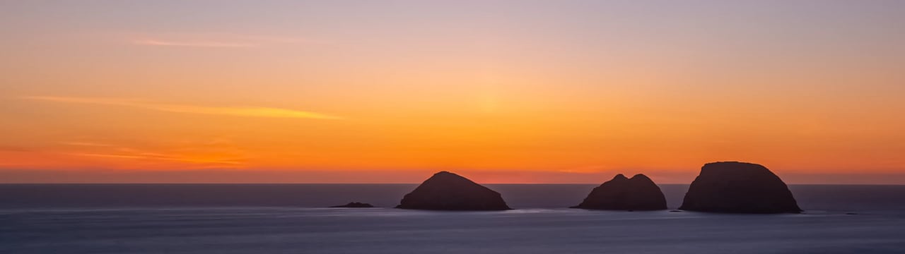 Timelapse sunset view of three rocks off Oceanside Oregon near dusk