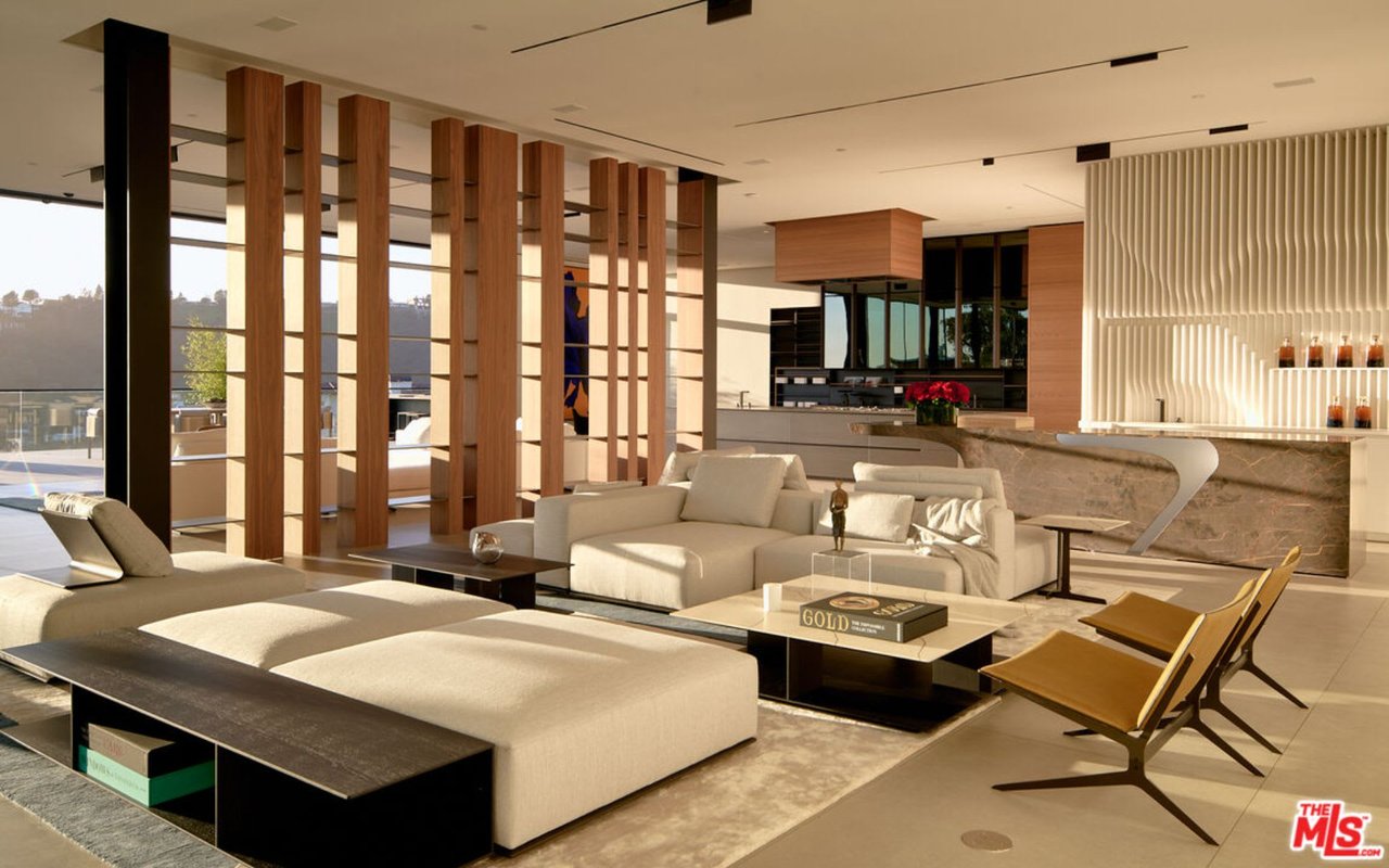  A spacious and ultra-modern open-concept living area with luxurious furnishings and architectural details. 