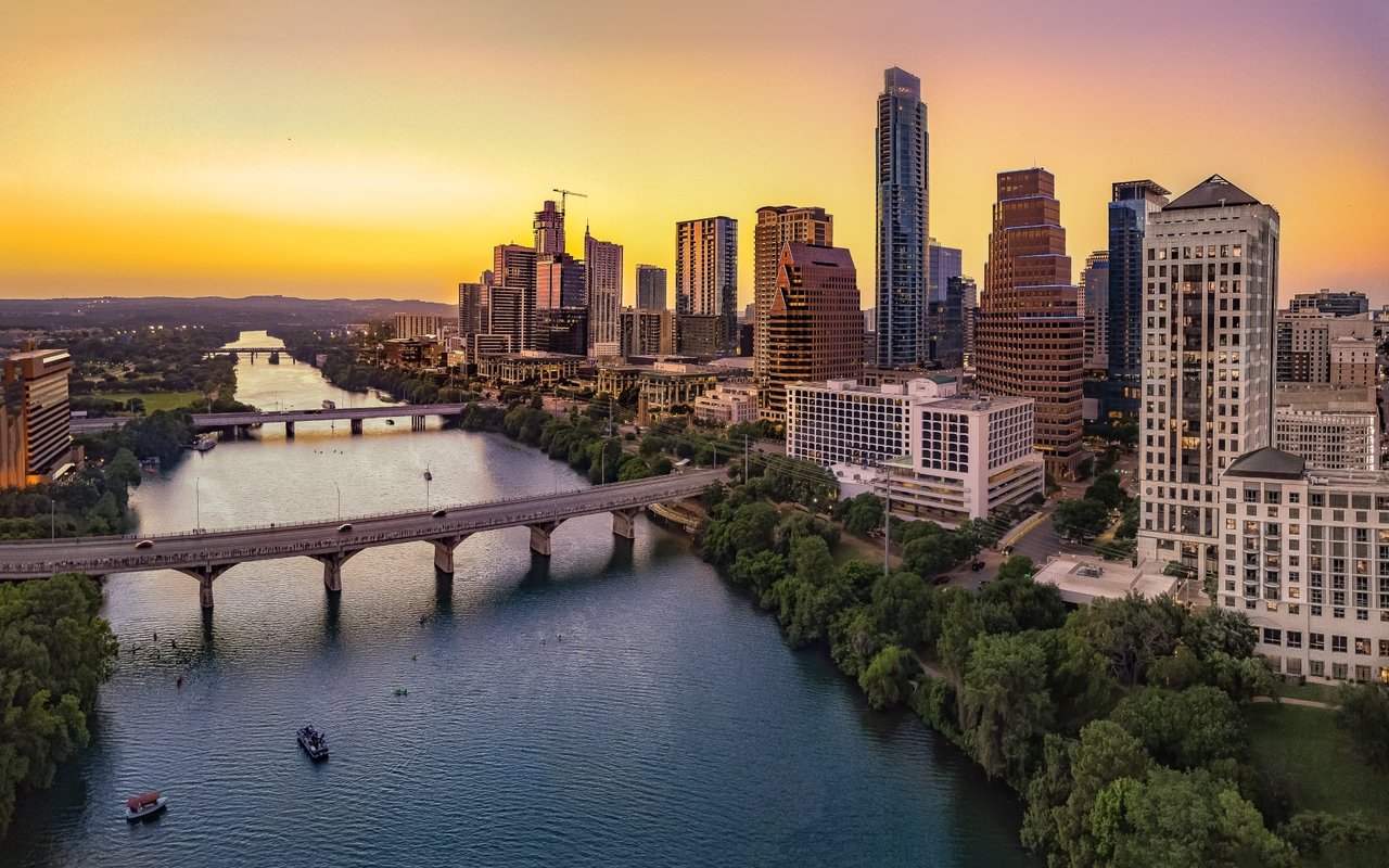 Aerial view of a city skyline at sunset. Julie Gray Real Estate Agent