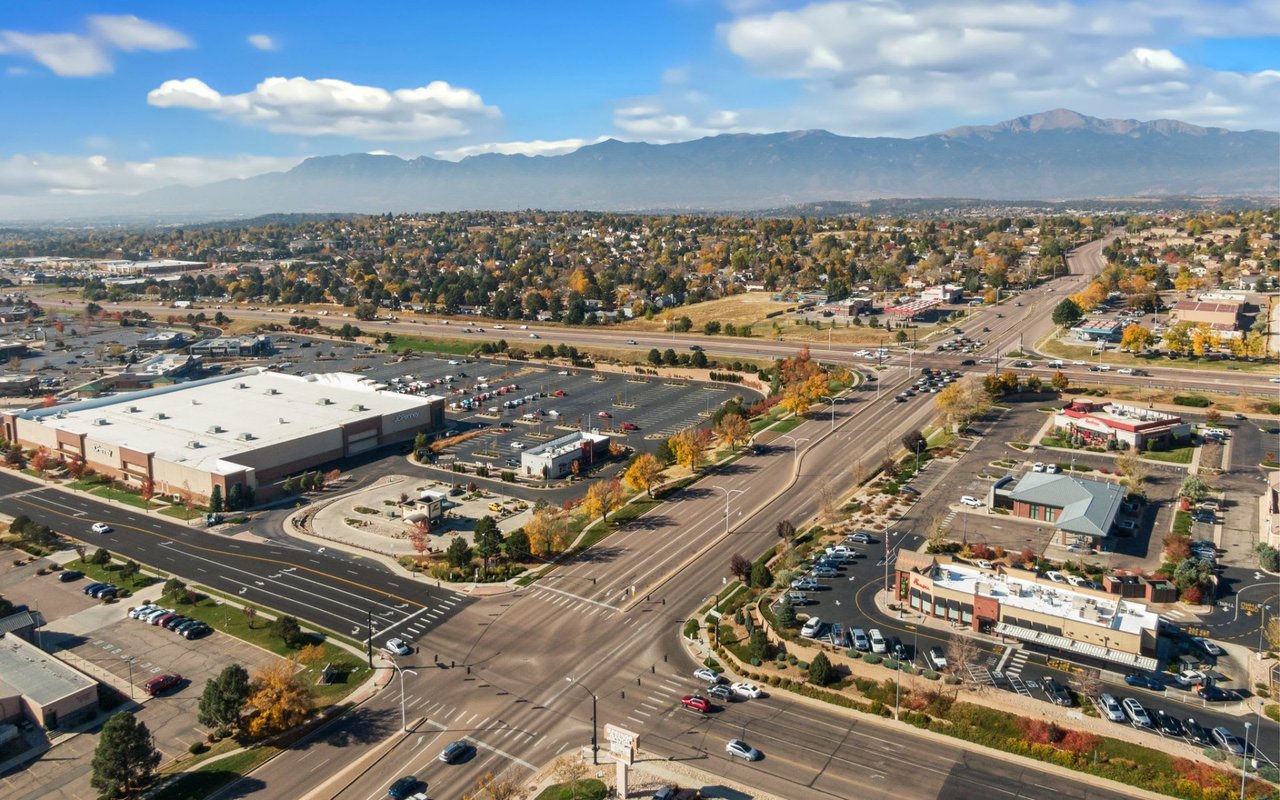 An aerial view of a suburban area with a large retail complex