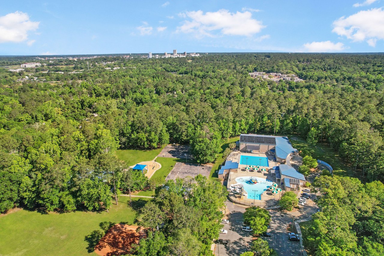 An aerial view of the Apalachee Ridge Estates neighborhood, highlighting houses and significant tree cover.