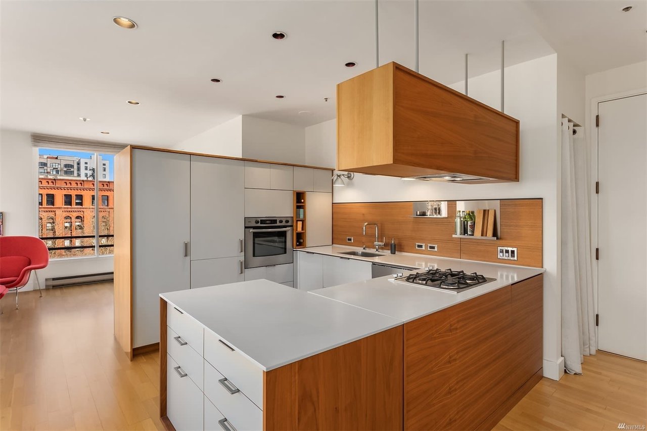 Stylish condo kitchen with wooden cabinets and a central island, blending modern design with city living.