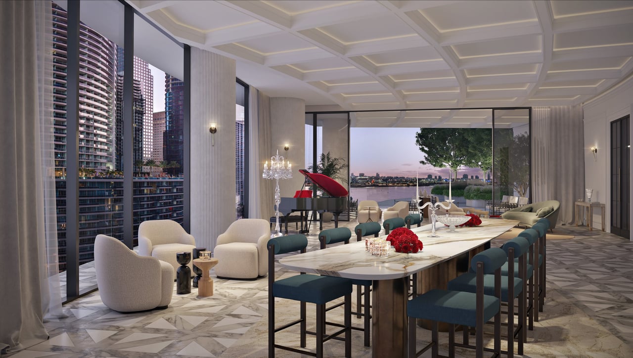 Elegant dining room with a marble table, grand piano, and dusk views of the water and skyline.