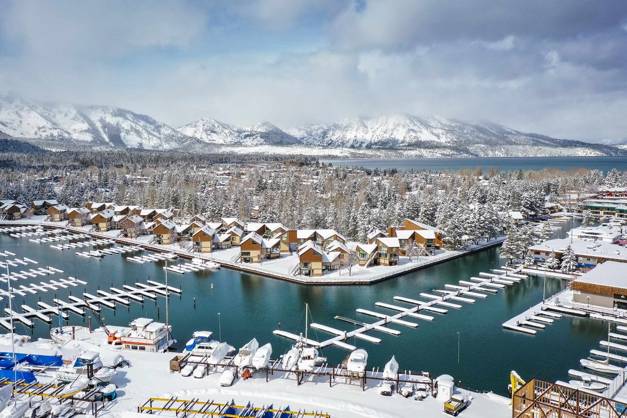 Scenic view of an affordable neighborhood near Lake Tahoe with mountain backdrop and lake access, ideal for home buyers seeking budget-friendly homes in the Lake Tahoe area.