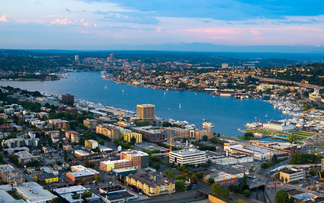  An aerial view of Lake Union in Seattle, Washington, with the city skyline surrounding the water. 