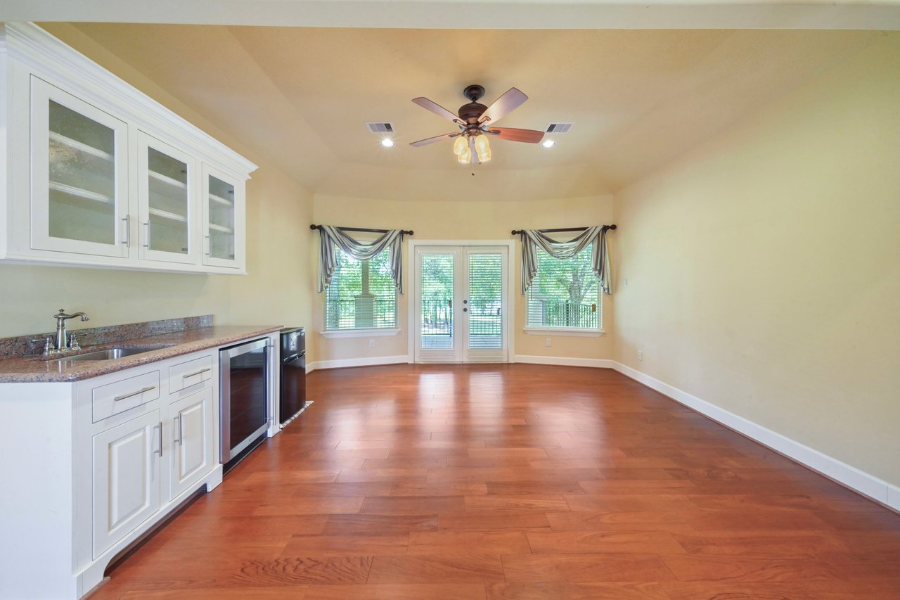 2nd floor gameroom with kitchenette and double doors leading to the balcony.