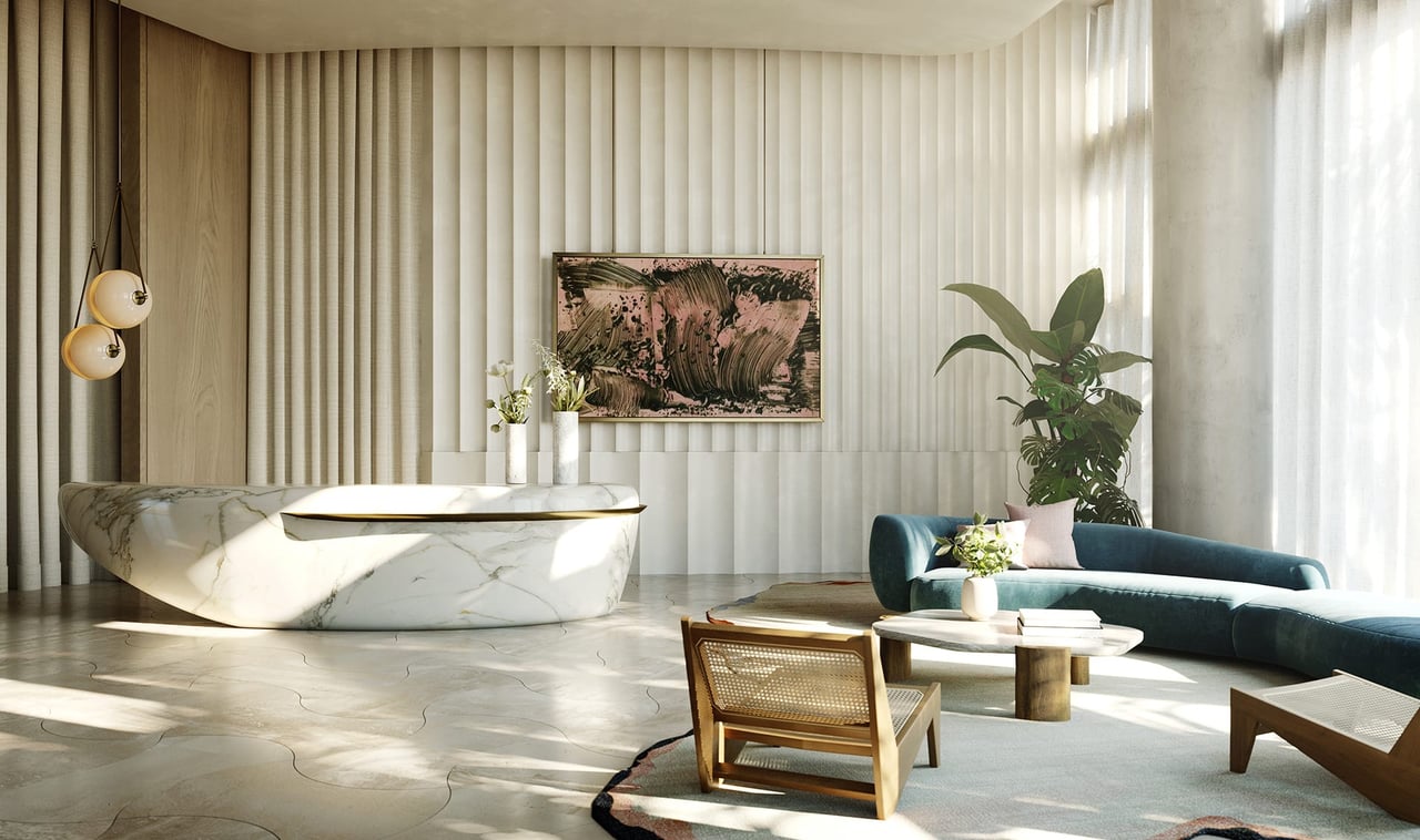 Luxury bathroom lounge with a sculptural marble tub, teal sofa, and floor-to-ceiling windows.