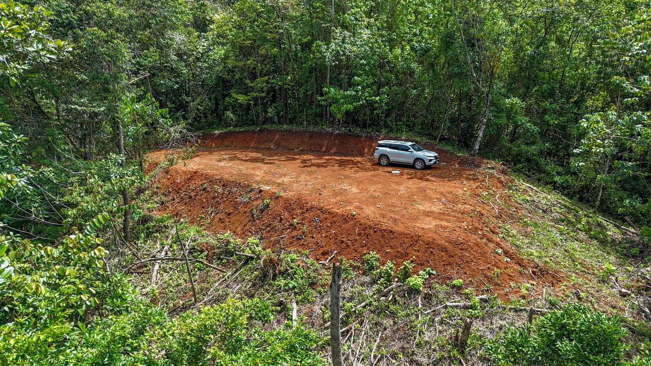 A jungle – and – creek border 1. 6 acre lot in a secure gated community, prepared and ready for your dream home!. 