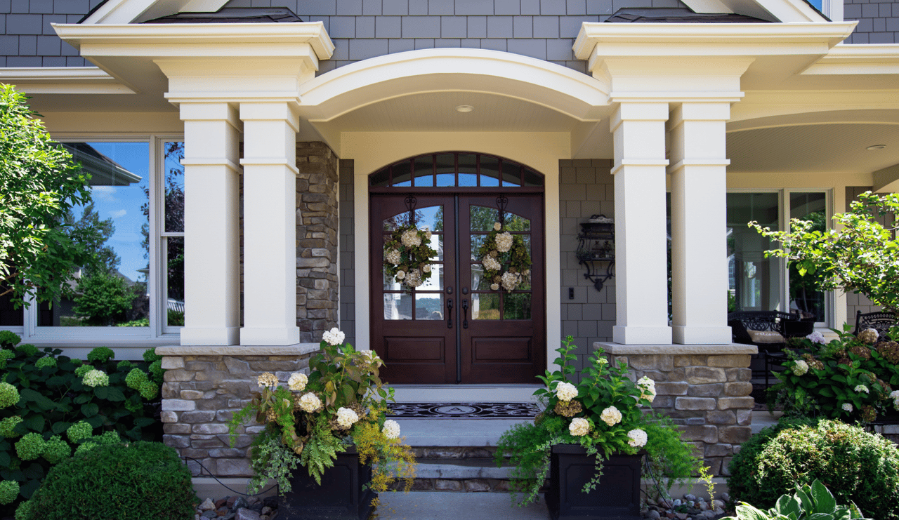 a front door of a house with a wreath hanging on it