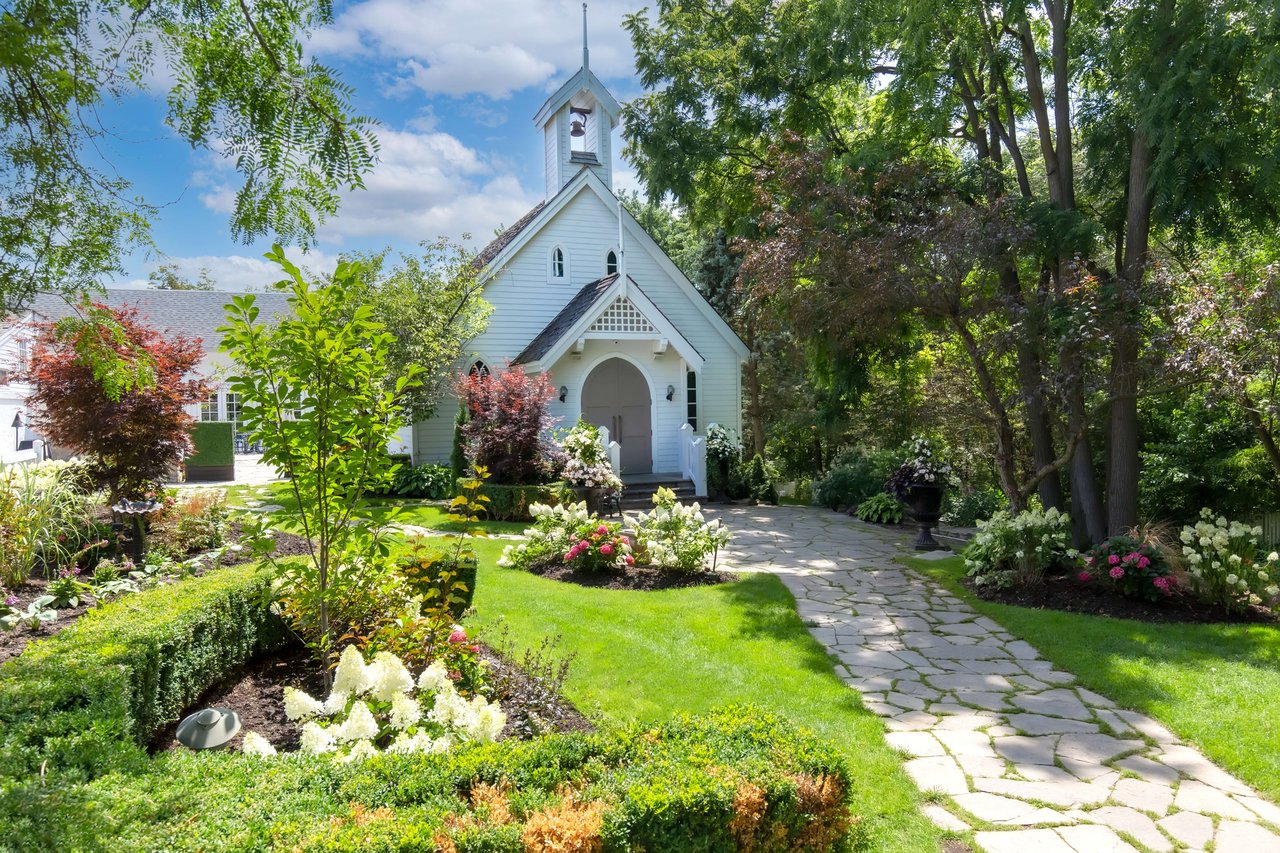 A small white church with a bell tower and steeple