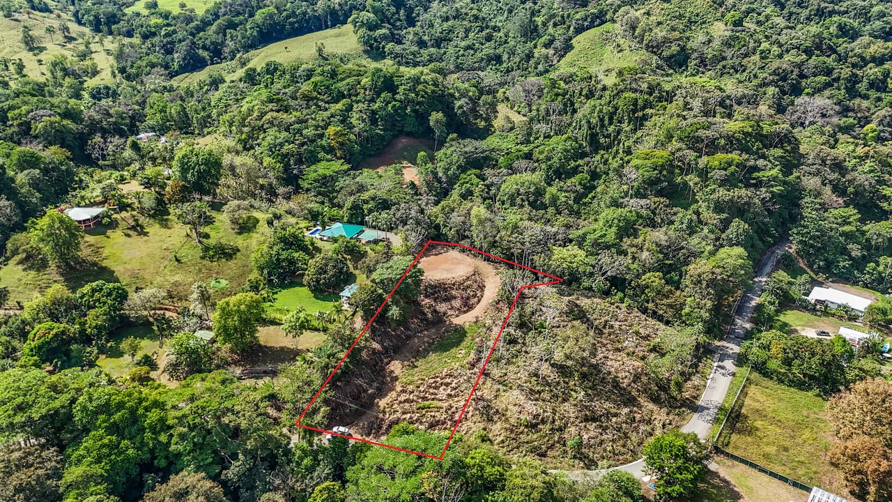 An elevated 1.2 acres lot with two plantels, panoramic mountain and jungle views.