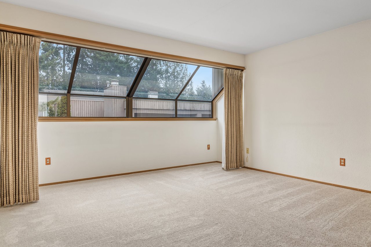 These windows add charm and character to the primary bedroom. 