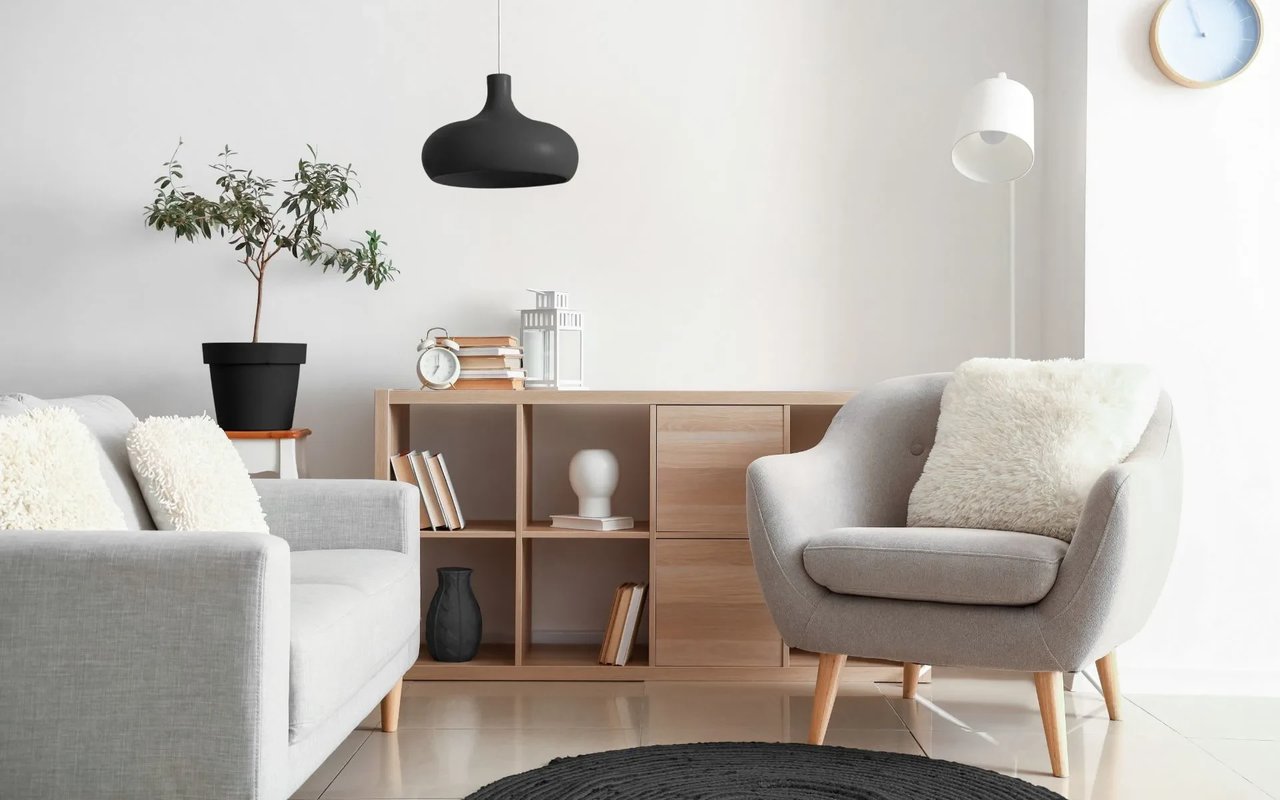 A living room with a plush couch, a cozy armchair, and a shelf, located in a Westlake Village, California home.