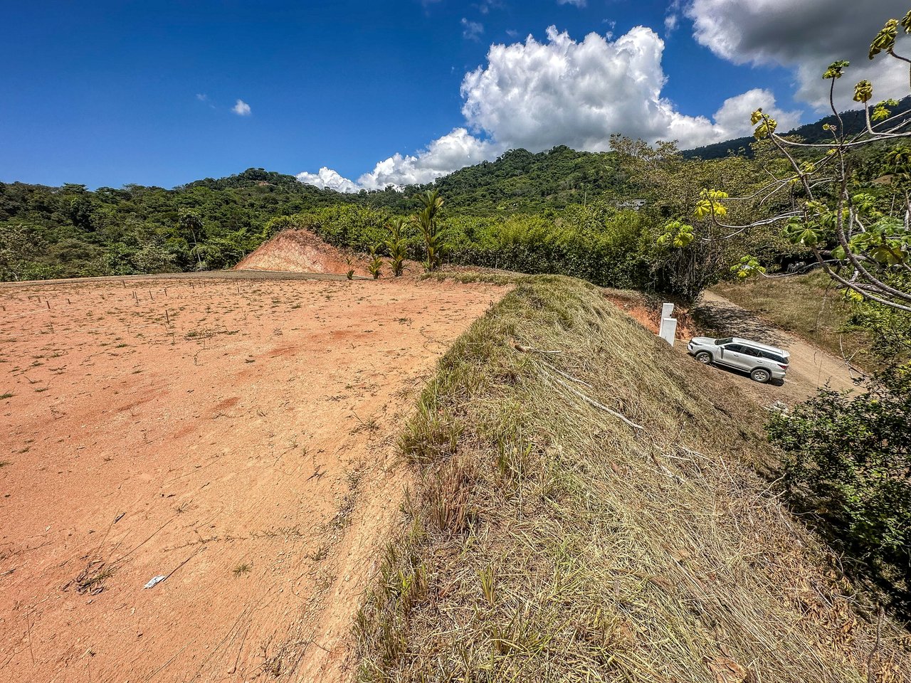 An elevated, prepared river lot with 360-degree ocean, mountain, valley and jungle views