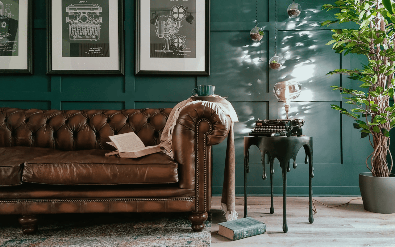  A cozy and stylish room with a dark teal paneled wall.