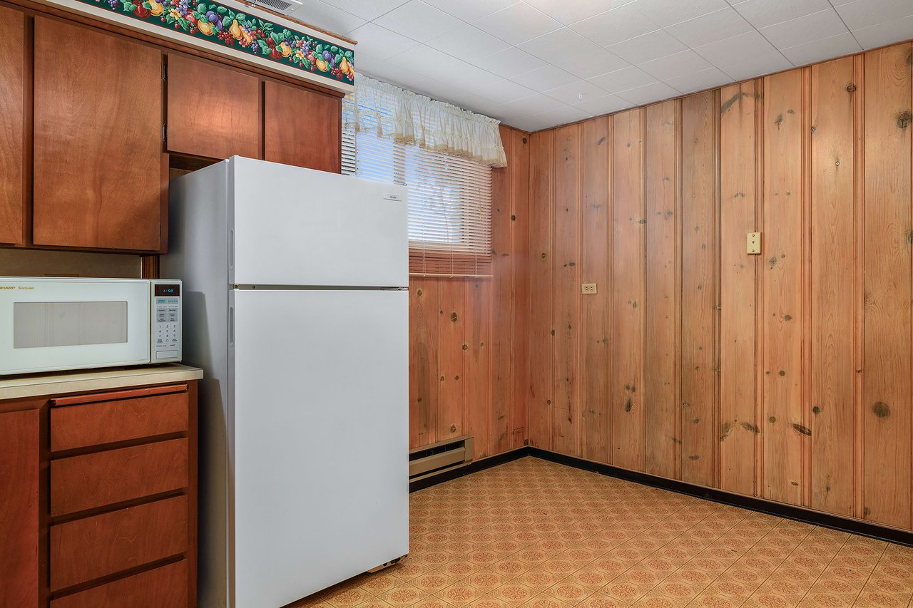 Simplify mealtime in the downstairs kitchen with ample space for dining.