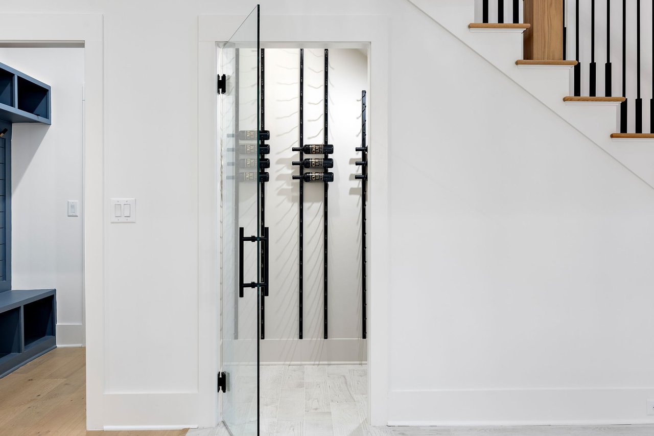 Luxurious wine cellar in the Ridgewater Bleu home, Marietta GA, boasting custom-built shelving and exquisite design, tailored for wine enthusiasts seeking elegance and functionality.