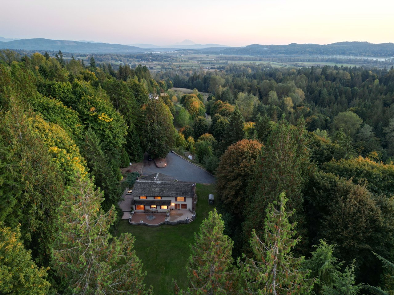 Step back and take in the expansive view of this impressive home, with its elegant design and inviting outdoor spaces, creating a welcoming and beautiful residence.