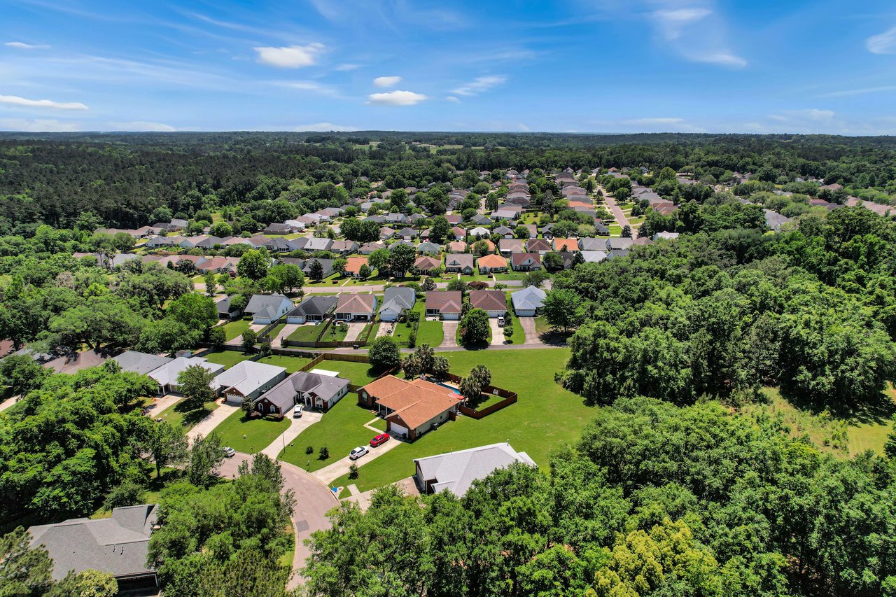 Another aerial view of Piney-Z, highlighting the layout of houses, streets, and green spaces.