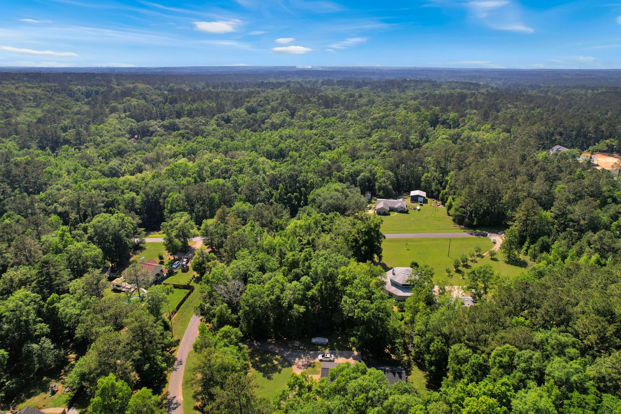 An aerial view of the Miccosukee Land Cooperative community, focusing on the natural surroundings and residential properties.