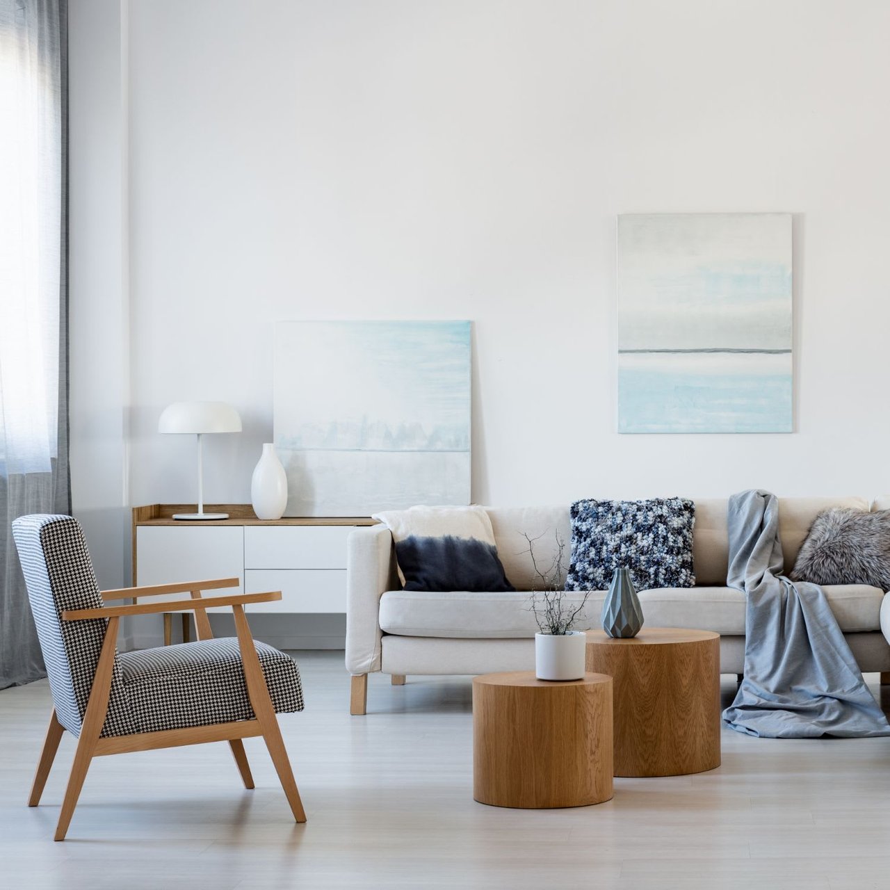  A brightly lit living room with white walls and light-colored flooring. 