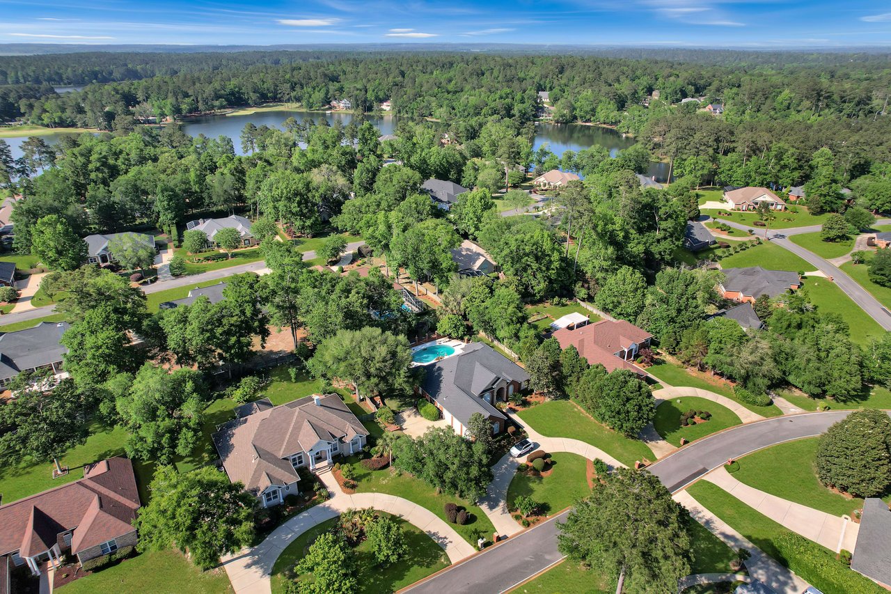 An aerial view of the Golden Eagle community, highlighting houses, streets, and a nearby lake.