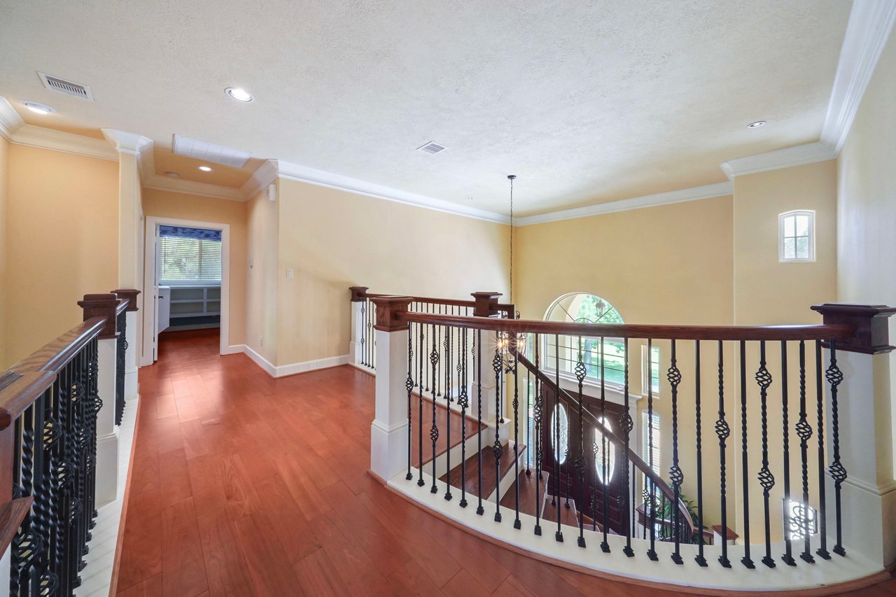 Top of the grand stairway from the front main entry. There is another stairway that leads from the 2nd floor to 1st floor kitchen hallway. There is a ensuite bedroom and second office on this side of home.