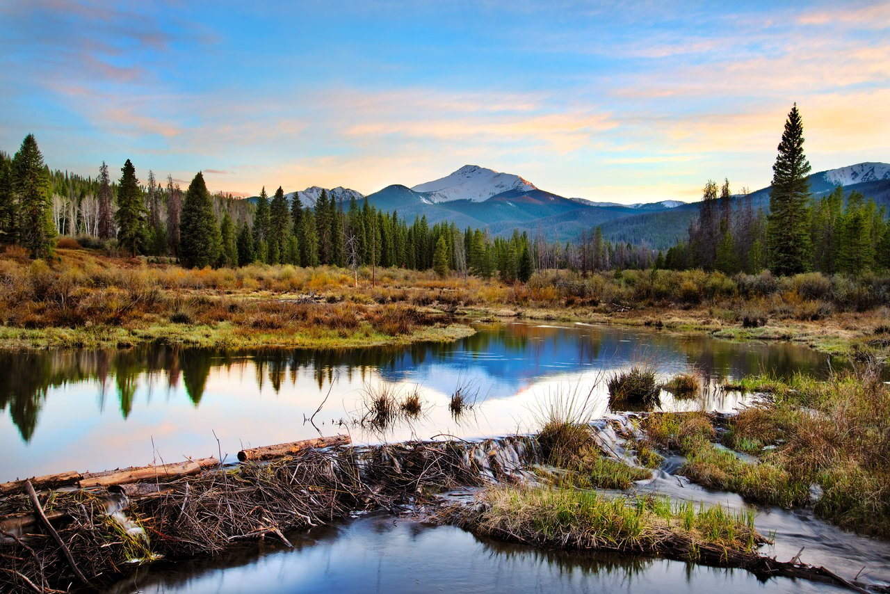 A serene lake with a snow-capped mountain in the background