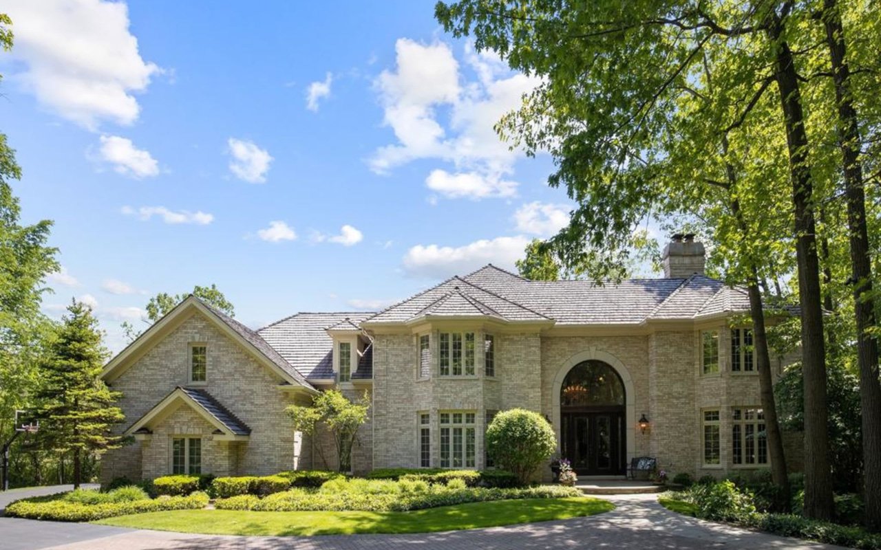 This Stately Brick Traditional Home Is Uniquely Positioned On One Of The Most Private Lots In Royal Melbourne