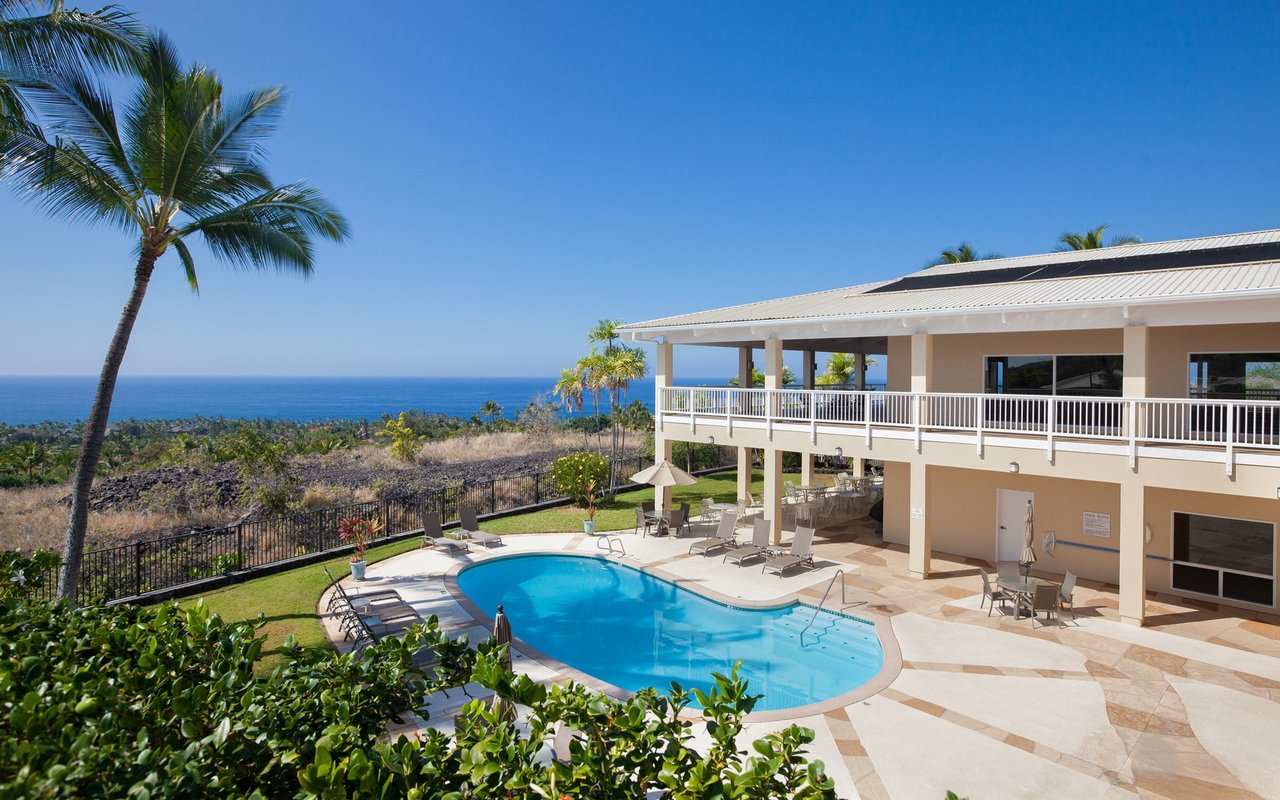 A large modern resort with a pool and a view of the ocean