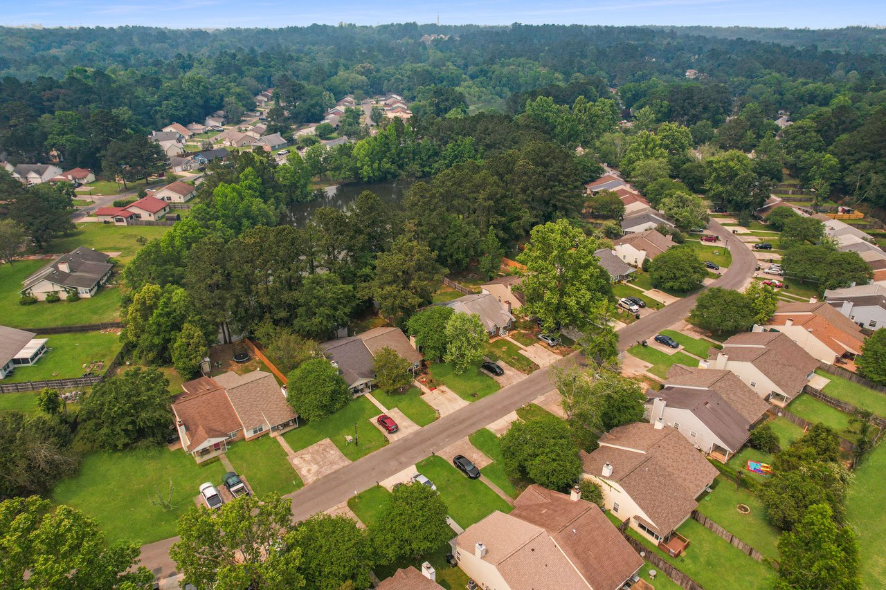 An aerial view of the Hartsfield Village community, highlighting the layout of houses, streets, and green spaces.