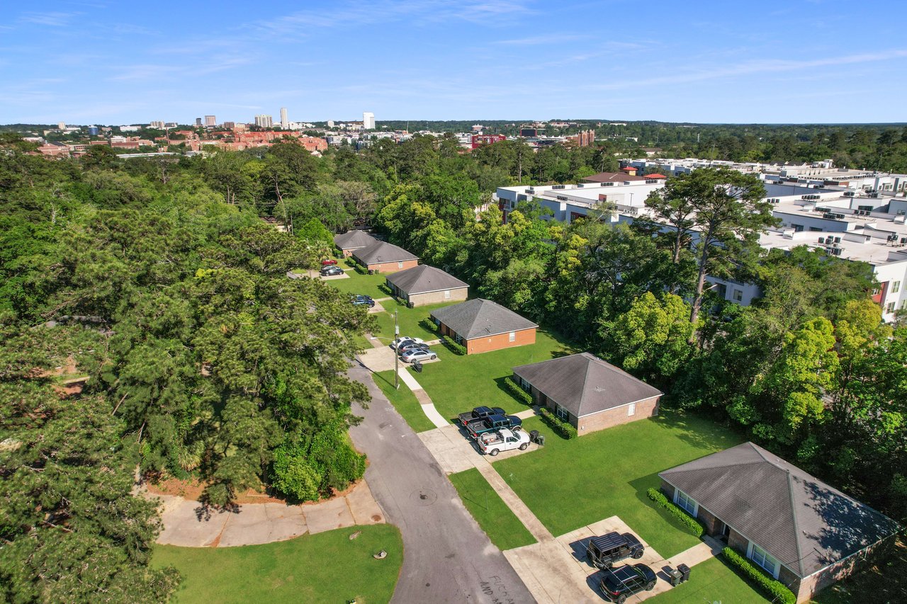 An aerial view of the Chapel Hill community, showing houses, streets, and surrounding green spaces. The area appears well-planned and residential.