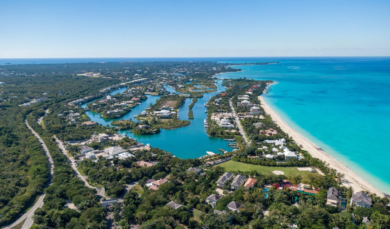 An aerial view of a canal leading to a beach.