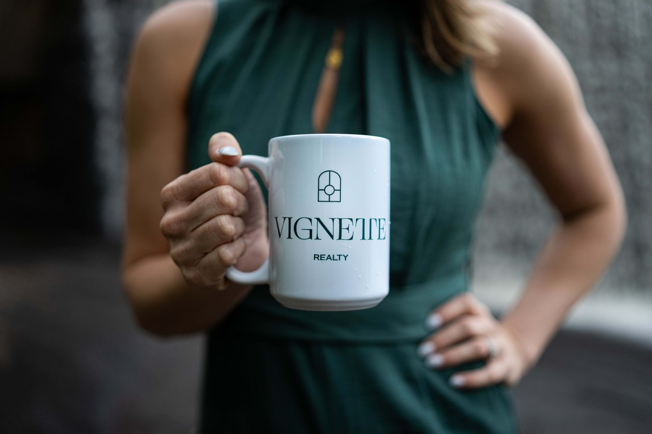 Picture of a vignette realty cup being held by a woman