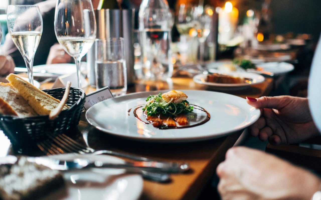 Diners gathered around a table filled with delicious dishes.