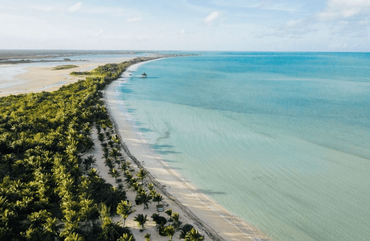 An aerial view of a beautiful beach with turquoise water.